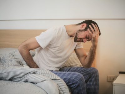distraught man getting out of bed